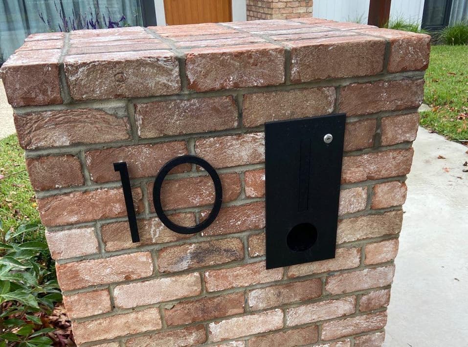 house number on brick wall